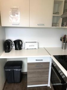 a kitchen with a counter with a sink and a stove at Appartment Hotel Garni Elisabeth in Göppingen