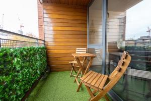 un patio con 2 sillas y una mesa en el balcón en GuestReady - Modern retreat in Liverpool en Liverpool