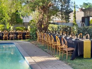 a table set up for a party next to a pool at Villa54 in Gaborone