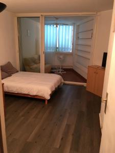 a bedroom with a bed and a sliding glass door at Studio 233, Port Camargue, Parking, WiFi, Piscine, 2 personnes in Le Grau-du-Roi