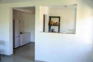 a white room with a refrigerator and a mirror at Vila Bucovina in Ciocăneşti