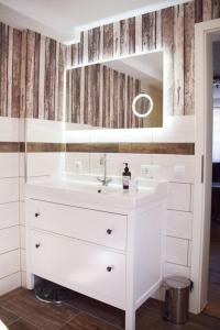 a white bathroom with a sink and a mirror at Maison Harzliesel in Harzgerode +9 photos