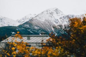 a snow covered mountain in the distance with a building at Innsbruck Studio by MO in Innsbruck