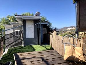 a wooden deck with a door on a fence at Extraordinary Boat House in Las Zocas