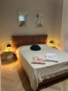 a bedroom with a bed with two towels on it at Lunaria in Pisa