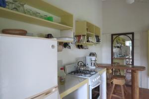 a small kitchen with a stove and a refrigerator at Apartamento Karibu in Manuel Antonio