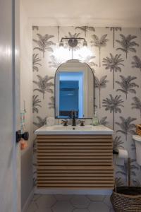 a bathroom with a sink and a mirror at Beach Block-1min Walk-Luxury-The Reef Downstairs in Ocean City