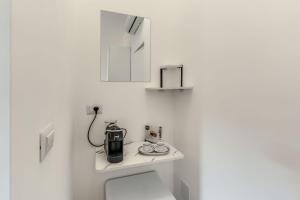 a bathroom with a coffee maker on top of a toilet at Vatican Portrait Suites in Rome