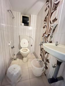 a bathroom with a toilet and a sink at HAKUNA MATATA - Best budget stay at Arambol Beach, Goa in Arambol