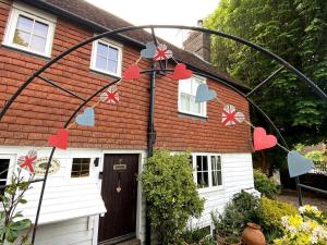 a house with hearts garland outside of it at Chestnut Tree Cottage, 7 High Street in Ardingly