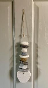 a stack of rocks sitting on top of a mirror at Chestnut Tree Cottage, 7 High Street in Ardingly