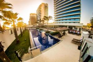 a view of a building with a swimming pool at Laghetto Stilo Barra in Rio de Janeiro