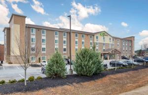 a large building with cars parked in a parking lot at Extended Stay America Suites - Atlanta - Lithia Springs in Lithia Springs