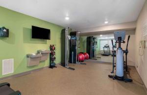 a gym with several machines and a flat screen tv at Extended Stay America Suites - Atlanta - Lithia Springs in Lithia Springs
