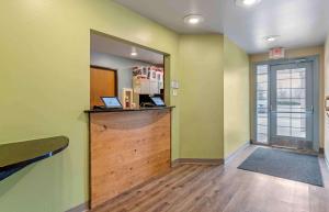 a lobby with a counter with two laptops on it at Extended Stay America Select Suites - Indianapolis - Greenwood in Greenwood