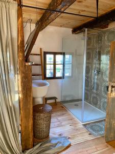 a bathroom with a glass shower and a sink at Estate Ana in Ptuj