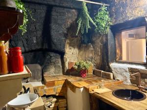 a bathroom with a sink and a stone wall at Estate Ana in Ptuj +63 photos
