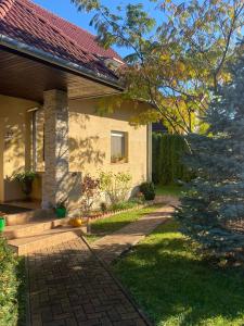 a house with a brick walkway in front of it at Jasmin Apartment House in Vonyarcvashegy