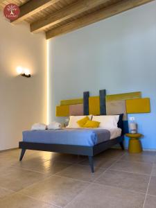 1 dormitorio con 1 cama con cabecero de madera en I SECOLARI en Sannicandro di Bari