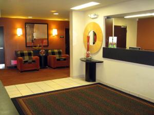 a lobby with a waiting room with chairs and a mirror at Extended Stay America Suites - Wilmington - New Centre Drive in Wilmington