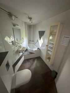 a white bathroom with a sink and a toilet at Hotel de Watertoren in Dordrecht +29 photos