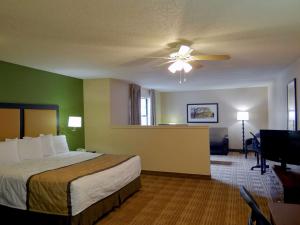 a hotel room with a bed and a ceiling fan at Extended Stay America Suites - Wilmington - New Centre Drive in Wilmington