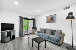 a living room with a couch and a tv at West Brickell - #3 - Renovated 2 1 & Parking in Miami