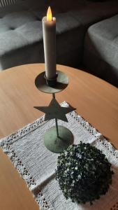 a candle and a star on a table at Haus Gmahblick Ferienwonungen in Alpbach