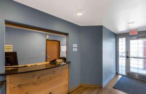 an office with a reception desk and a mirror at Extended Stay America Select Suites - Denver - Aurora in Aurora