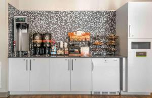 a kitchen with white cabinets and a counter top at Extended Stay America Suites - Detroit - Rochester Hills in Rochester Hills