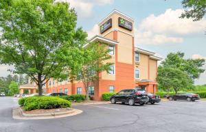 a building with a clock tower in a parking lot at Extended Stay America Suites - Charlotte - Tyvola Rd in Charlotte