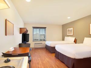 Habitación de hotel con 2 camas y escritorio en Extended Stay America Select Suites - Birmingham - Pelham, en Pelham