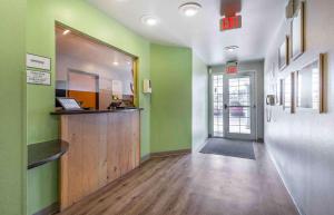 Habitación con paredes verdes, barra y pasillo. en Extended Stay America Select Suites - Laredo, en Laredo
