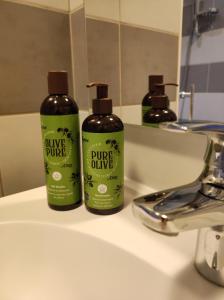 two bottles of divine plunge glide on a bathroom sink at Le LUX 11 in Thionville