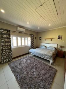 een slaapkamer met een bed en een tapijt bij Berg guest farm in Winterton