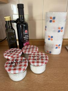 a group of four bowls on a counter with a bottle of wine at DOLOMITI HOUSE 6 in Fiera di Primiero