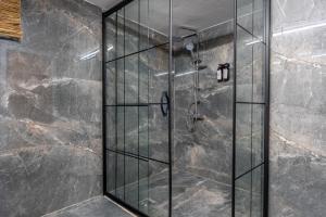 a shower with a glass door in a bathroom at Antalya B&B Hotel in Antalya