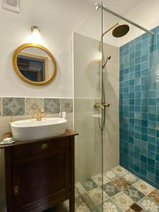 a bathroom with a sink and a shower at ZebRegény Vendégház in Zebegény