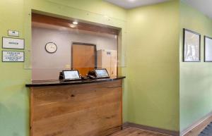 a room with a counter with a clock on the wall at Extended Stay America Select Suites - Phoenix - West in Phoenix