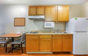a kitchen with a sink and a white refrigerator at Extended Stay America Select Suites - Phoenix - West in Phoenix