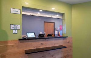 a mirror in a waiting room with a check in counter at Extended Stay America Select Suites - Panama City - Callaway in Callaway