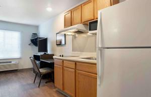 a kitchen with a white refrigerator and a sink at Extended Stay America Select Suites - Panama City - Callaway in Callaway