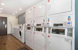 a laundry room with white washer and dryer machines at Extended Stay America Select Suites - Panama City - Callaway in Callaway