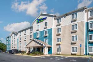 a hotel with a blue and white building at Extended Stay America Select Suites - Tallahassee - Northwest in Tallahassee