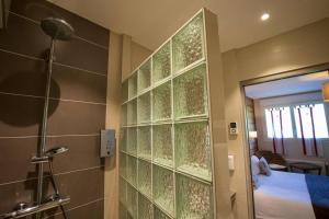 a bathroom with a shower and a glass wall at Logis Le Vernay in Autrans