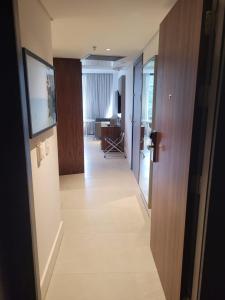 a hallway leading to a living room with a television at Hotel Nacional in Rio de Janeiro