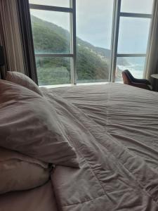 a bed in a room with a large window at Hotel Nacional in Rio de Janeiro