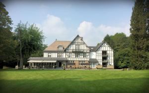 a large house with a green lawn in front of it at Lafarques in Pepinster