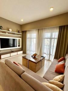a large living room with a couch and a tv at SunShine AbuTig Marina in Hurghada
