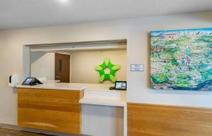 a reception desk with a large painting on the wall at Extended Stay America Suites - Tampa - Northeast in Tampa